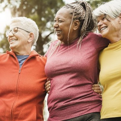 Group of women with arms around each other.